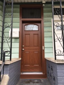A faux wood entry door